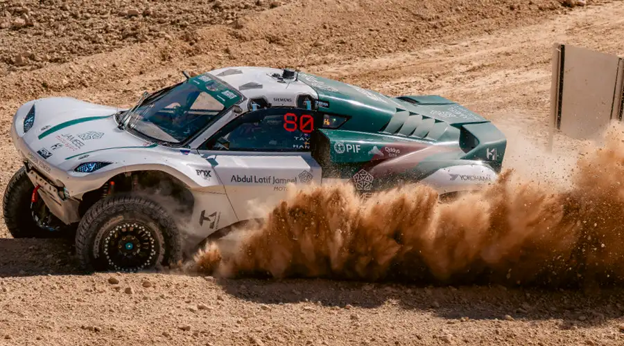 The rugged Pioneer 25 off-roader, equipped with a hydrogen power unit, kicks up a cloud of sand during the debut FIA Extreme H World Cup race in Saudi Arabia