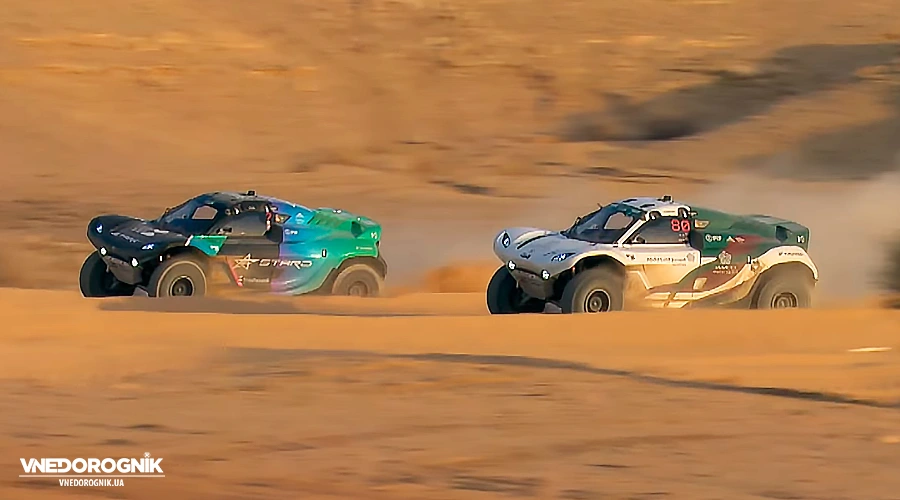 Two Pioneer 25 off-roaders engage in a wheel-to-wheel battle on the sandy track during the Multi-Car Racing stage.