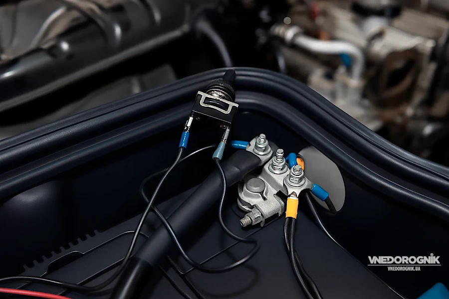 Toggle switch with a waterproof cap and connected terminals.