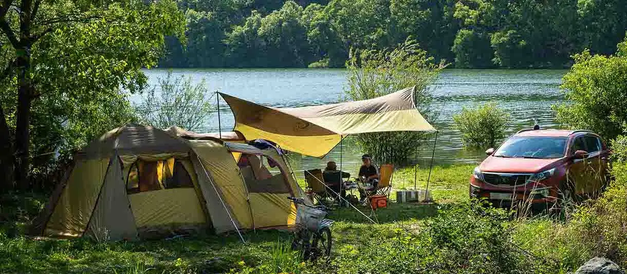 Tourist tent next to a car Tourist tent next to a car